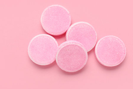 Soluble tablets on pink backgroundの写真素材