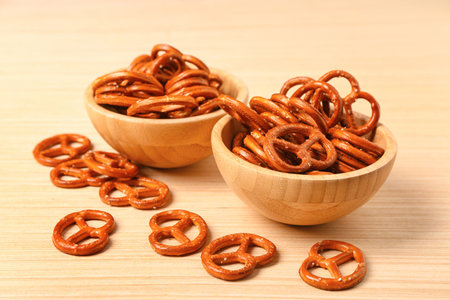 Bowls of tasty pretzels on wooden backgroundの写真素材