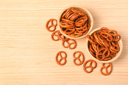 Bowls of tasty pretzels on wooden backgroundの写真素材
