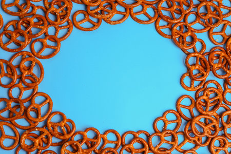 Frame made of tasty pretzels on color backgroundの写真素材