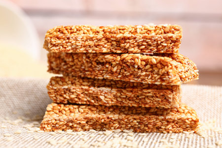 Stack of tasty sesame kozinaki on tableの写真素材