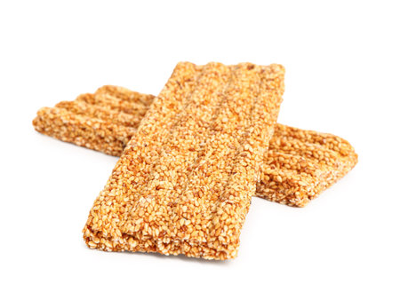 Sweet sesame kozinaki bars on white backgroundの写真素材