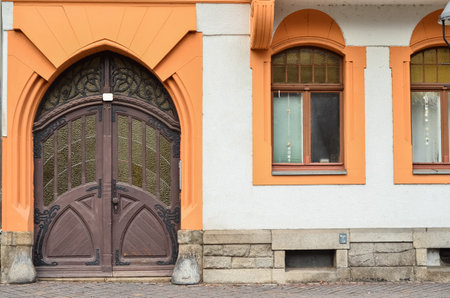 View of old building with wooden door and windowsの写真素材
