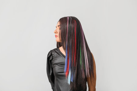Beautiful young woman with unusual hair on gray backgroundの写真素材