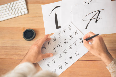 Senior male calligrapher working in officeの写真素材