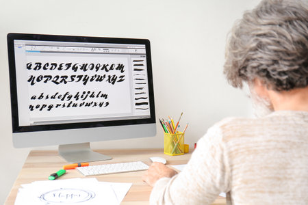 Senior male calligrapher working in officeの写真素材