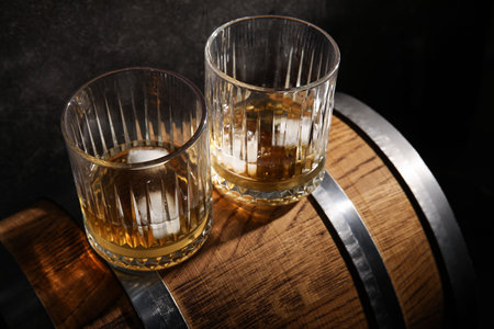 Barrel with glasses of cold whiskey on dark backgroundの写真素材