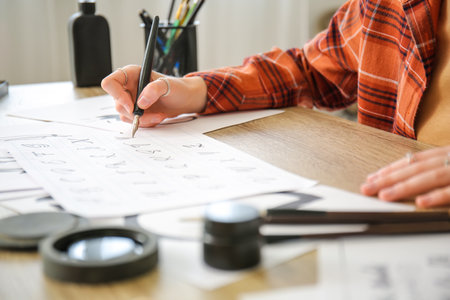 Female calligraphist working in office, closeupの写真素材