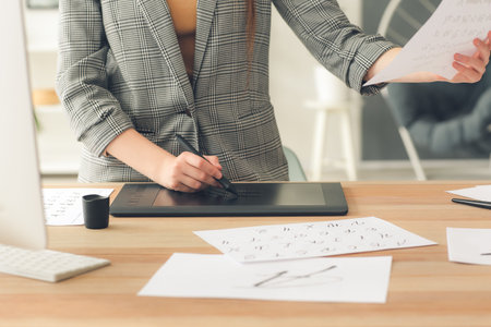 Female calligrapher working in office