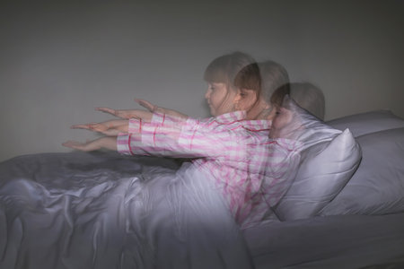 Little sleepwalker in bed at night, photo with stroboscopic effectの写真素材