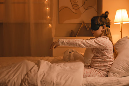 Little sleepwalker in bed at nightの写真素材