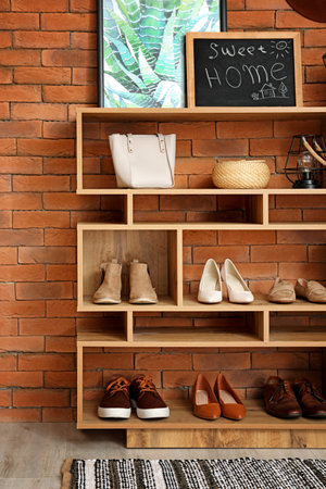 Shelf unit with shoes and accessories in stylish modern hallwayの写真素材