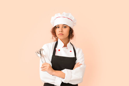Female African-American chef on color backgroundの写真素材