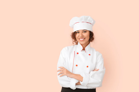 Female African-American chef on color backgroundの写真素材