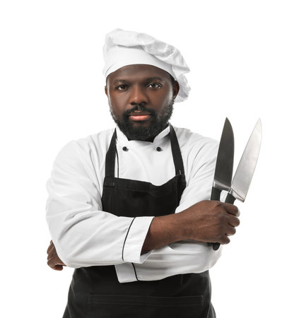 Male African-American chef with knives on white background