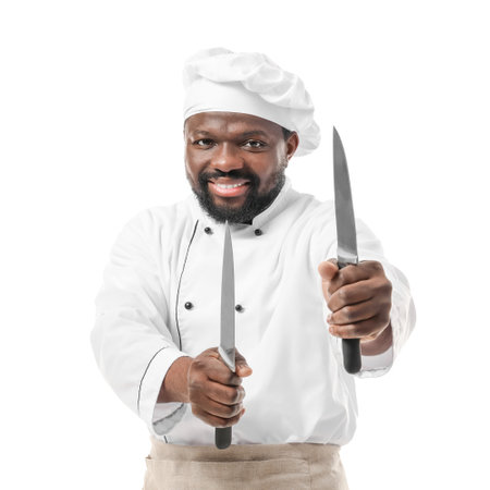 Male African-American chef with knives on white backgroundの写真素材