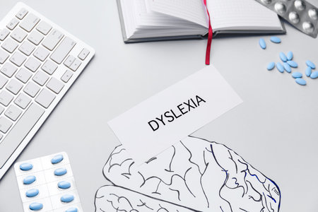 Imaging of human brains, pills and word DYSLEXIA on white backgroundの写真素材
