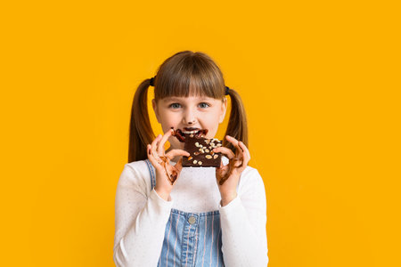 Cute funny girl with chocolate on color backgroundの写真素材