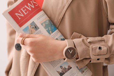Woman with stylish wrist watch and newspaper, closeupの写真素材