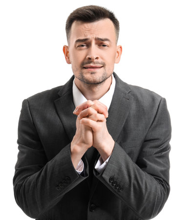 Portrait of apologizing businessman on white backgroundの写真素材