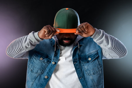 Male African-American hip-hop dancer on dark backgroundの写真素材