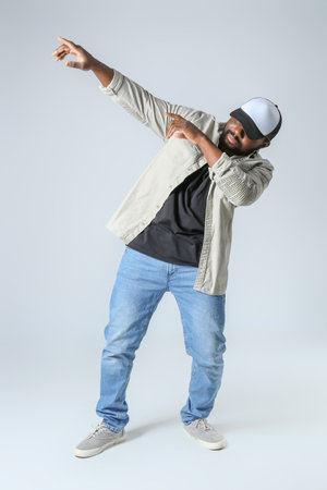 Male African-American hip-hop dancer on light backgroundの写真素材