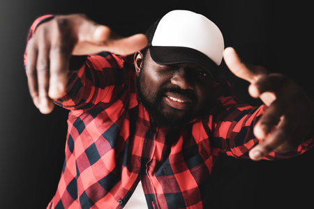 Male African-American hip-hop dancer on dark backgroundの写真素材