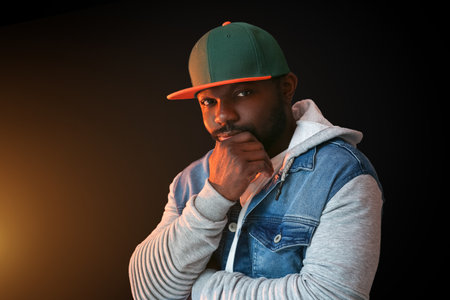 Male African-American hip-hop dancer on dark backgroundの写真素材