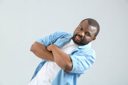 Male African-American hip-hop dancer on light backgroundの写真素材