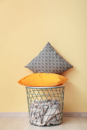 Table and soft cushions near color wall in room