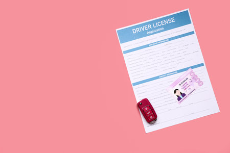 Driving license with application form and car key on color backgroundの写真素材