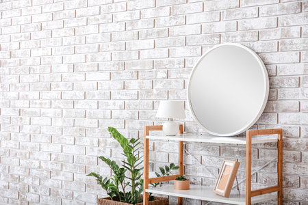 Stylish interior of room with shelving unit and mirrorの写真素材