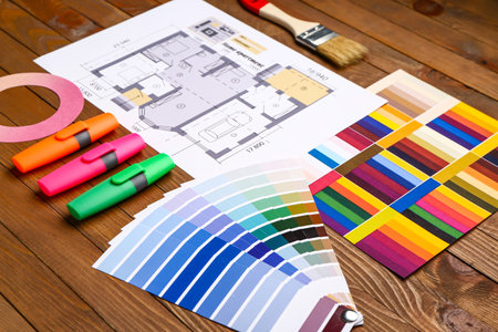 Color palettes with paint brush and building plan on wooden backgroundの写真素材