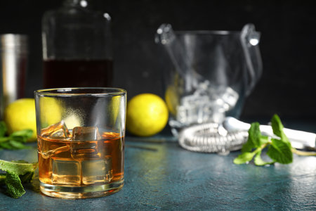 Glass of rum with ice cubes on dark backgroundの写真素材