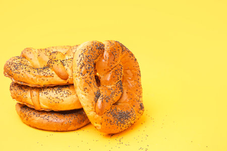 Stack of tasty pretzels on yellow backgroundの写真素材