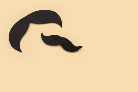 Black paper mustaches on color backgroundの写真素材