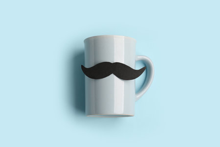 Cup with paper mustache on color backgroundの写真素材