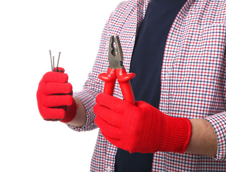 Man in gloves holding pliers and nails on white backgroundの写真素材