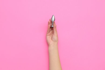 Woman with anal plug on pink backgroundの写真素材