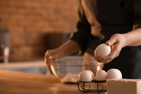 Woman making dough for pasta at table in kitchen, closeupの写真素材