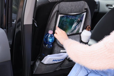 Woman using tablet computer in salon of carの写真素材