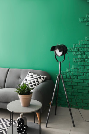 Stylish interior of living room with sofa, table and lampの写真素材