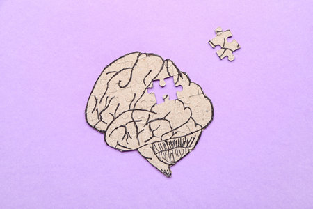 Puzzle in shape of human brain on color background. concept of dementiaの写真素材