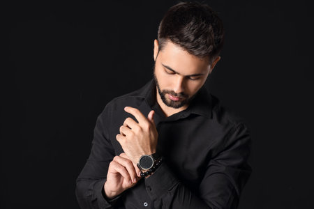 Stylish young man on dark backgroundの写真素材