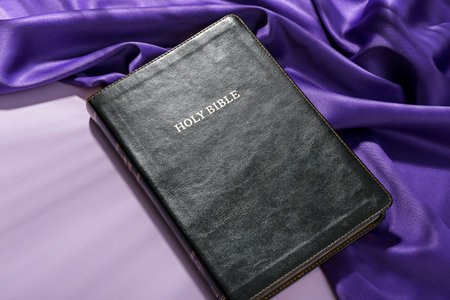 Holy Bible and purple fabric on lilac background. good friday conceptの写真素材