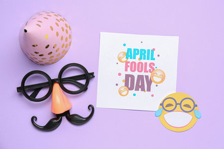 Card with text APRIL FOOLS DAY, party hat and funny disguise on lilac background