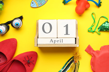 Calendar with date of April Fool's Day and funny decor on yellow backgroundの写真素材