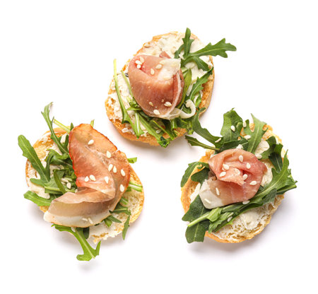 Tasty jamon bruschettas with arugula on white backgroundの写真素材