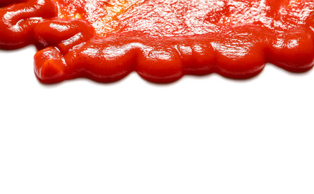 Spilled tasty ketchup isolated on white background, closeupの写真素材