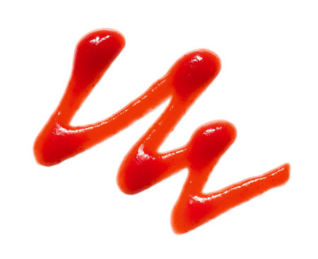 Spilled tasty ketchup isolated on white backgroundの写真素材